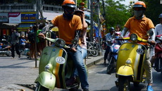 Touring Ho Chi Minh City in a retro Vespa mob